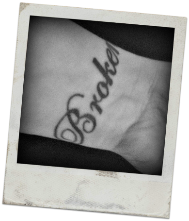 PHOTOGRAPH: A tattoo on a woman's wrist that reads 'Broken'.